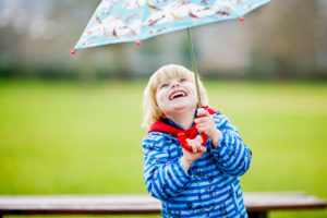 laughing boy with umbrella