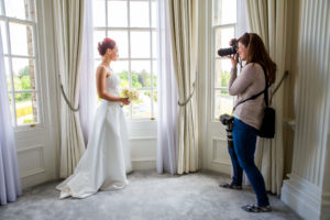 student taking wedding images